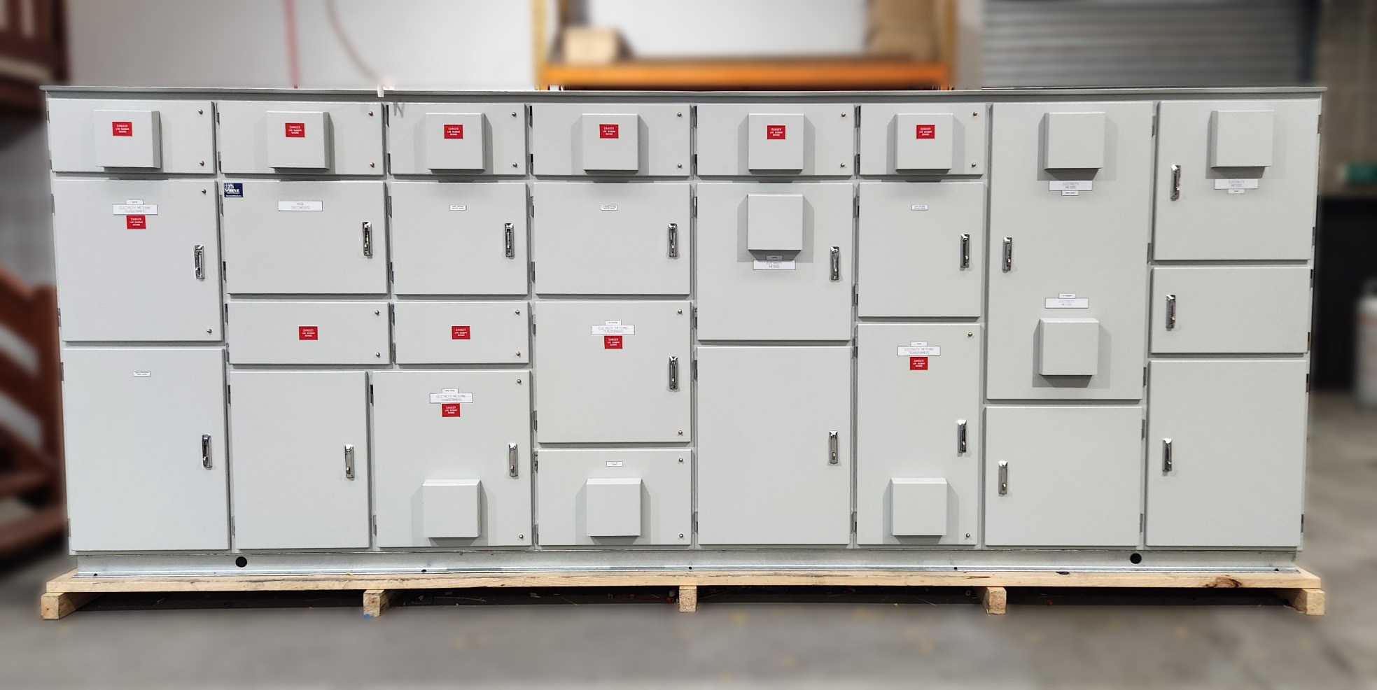 Large industrial main switchboard with multiple high-capacity circuit breakers and power distribution panels housed in an aluminium enclosure