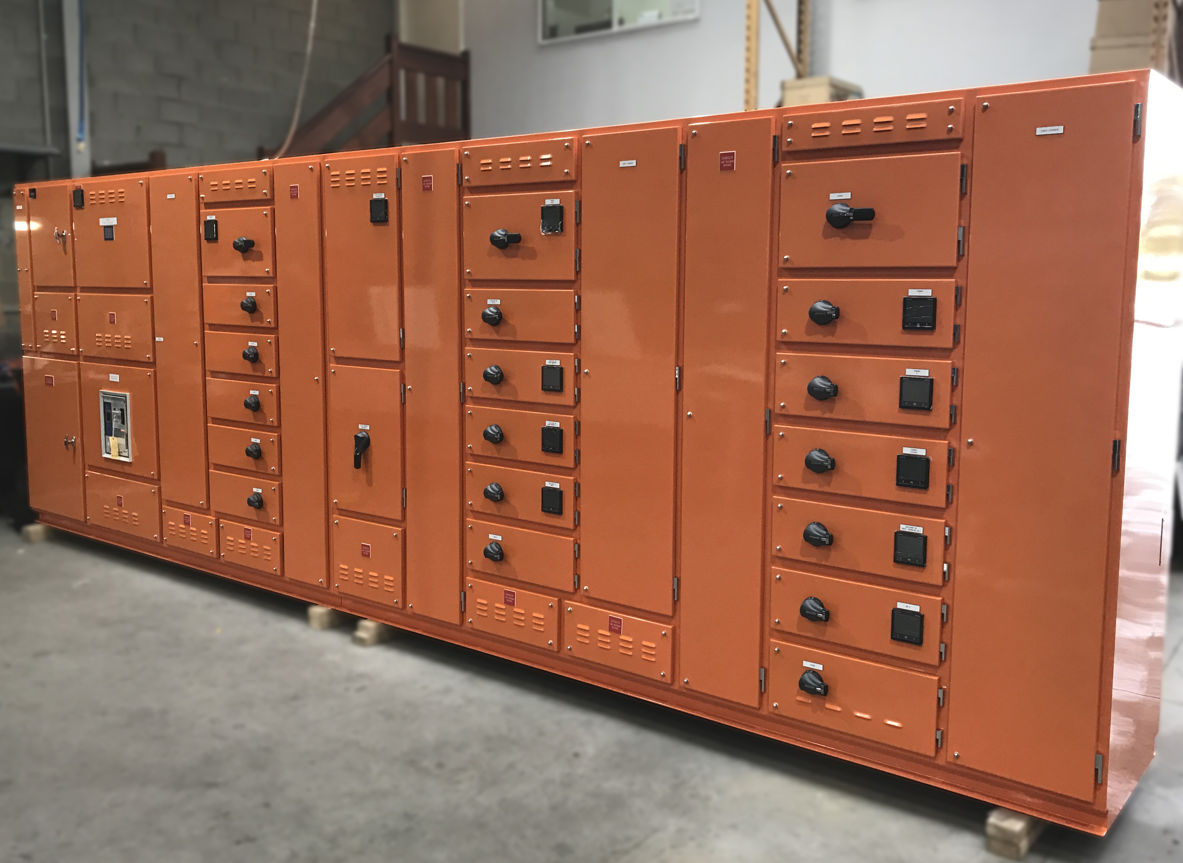 Large industrial switchboard fitted with multiple air circuit breakers for high-capacity power distribution, enclosed in a ventilated cabinet