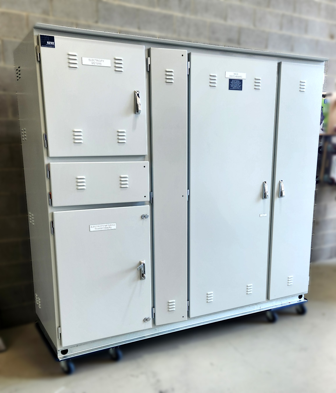 Compact free-standing industrial switchboard featuring neatly arranged breakers and labeled control switches in an aluminium enclosure